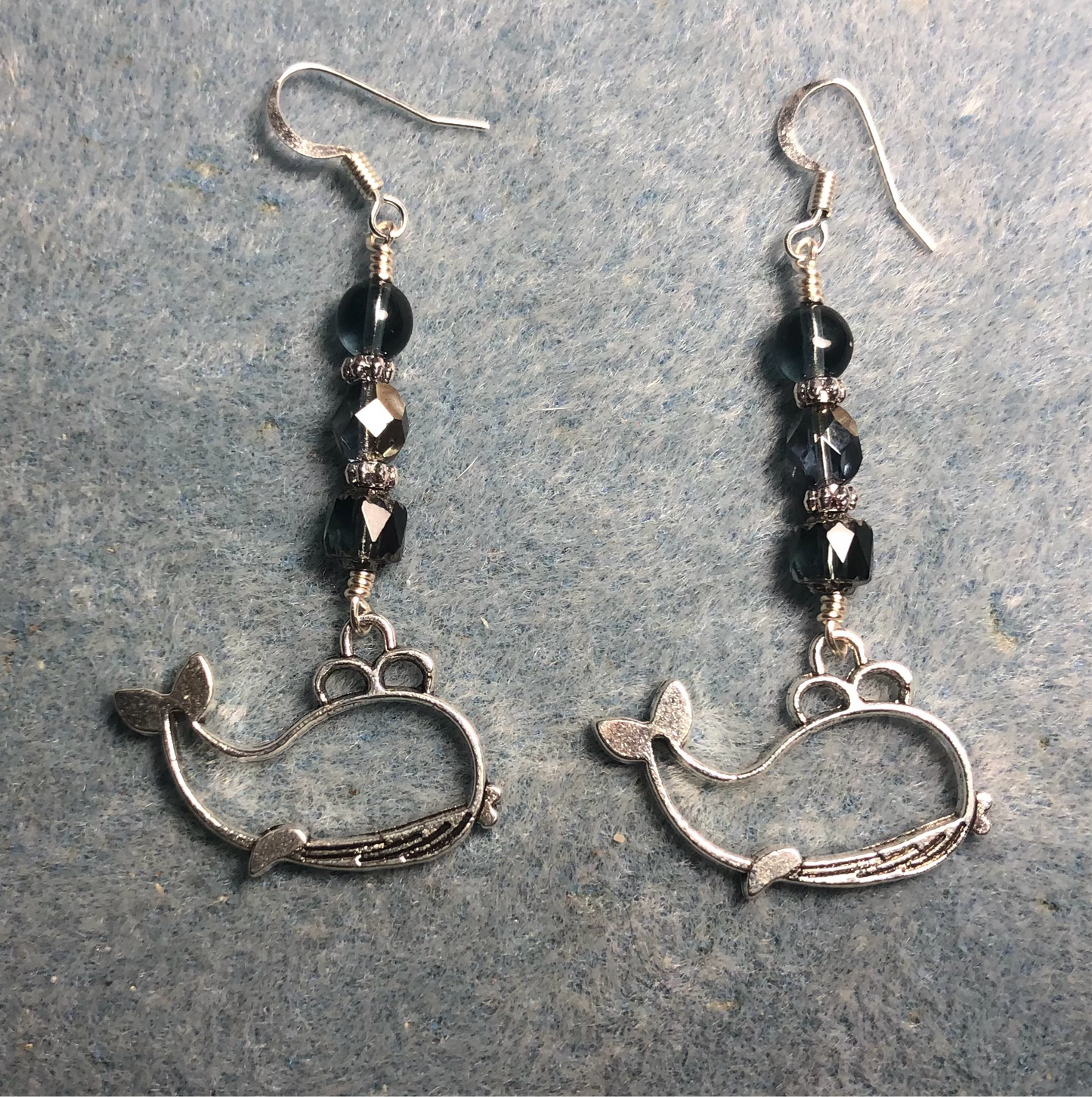 Silver spouting whale charm earrings adorned with Montana blue Czech glass beads