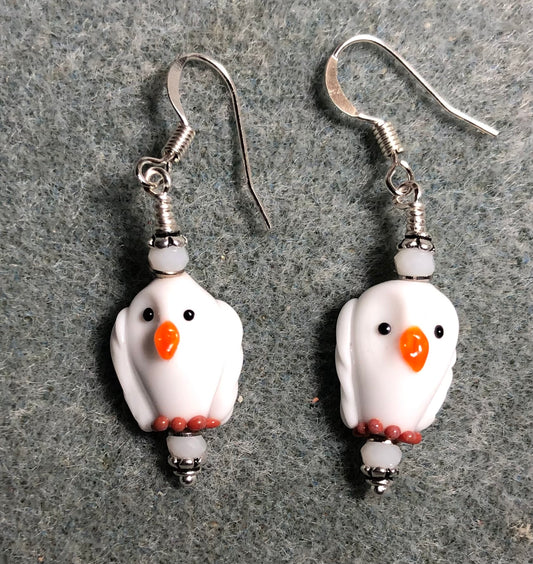 Small white and orange lamp work spotted owl bead earrings adorned with white Chinese crystal beads.