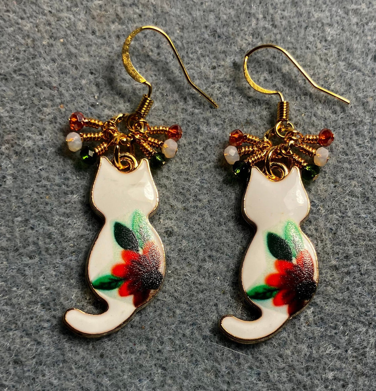 White, orange, and green enamel cat charm earrings adorned with tiny dangling white, orange, and green Chinese crystal beads.