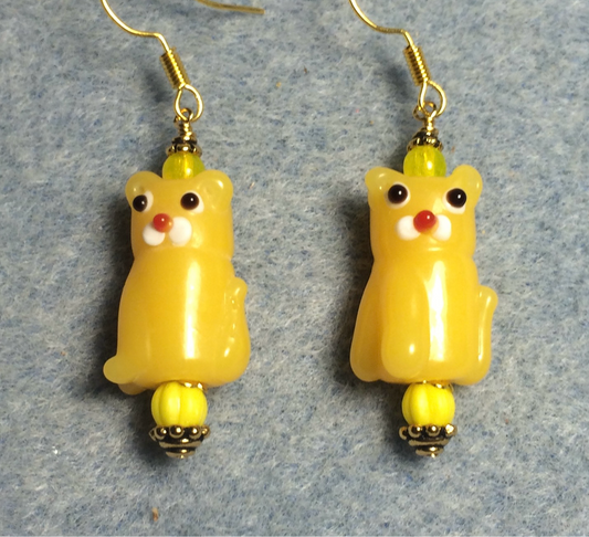Opaque golden yellow lamp work cat bead earrings adorned with yellow Czech glass beads.