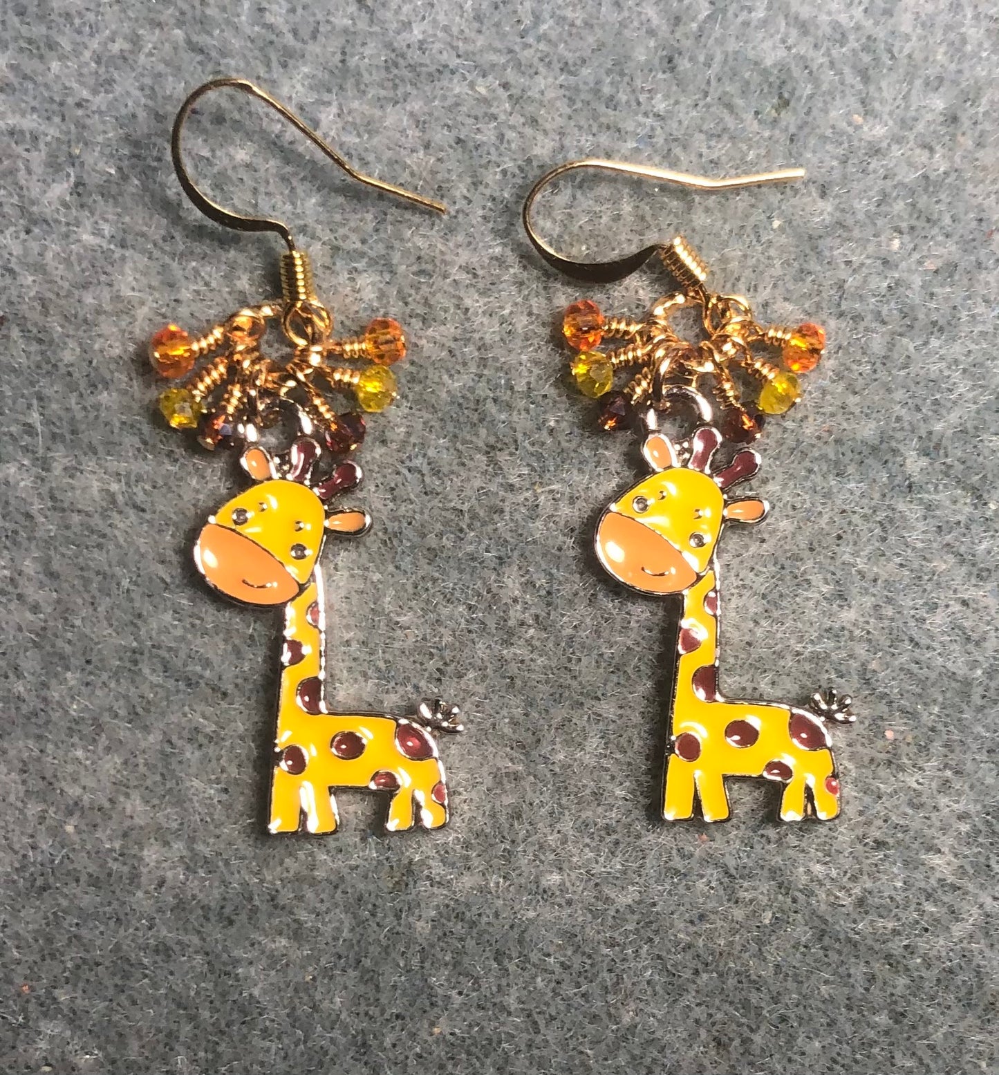 Golden yellow and orange enamel spotted giraffe charm earrings adorned with tiny dangling golden yellow, brown, and orange Chinese crystal beads.