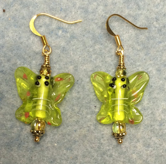 Lime green lamp work butterfly bead earrings adorned with lime green Czech glass beads.