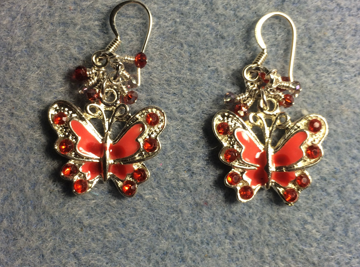 Red and orange enamel and rhinestone butterfly charm earrings adorned with tiny dangling red and orange Chinese crystal beads.