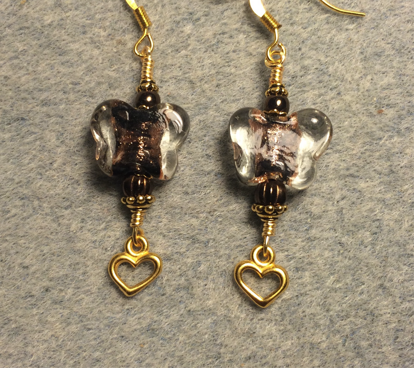 Brown lamp work butterfly bead earrings adorned with brown Czech glass beads and small gold Tierracast heart charms.