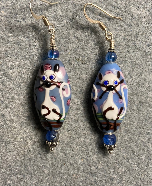 Blue, purple, and white lamp cat bead earrings adorned with blue Czech glass beads.