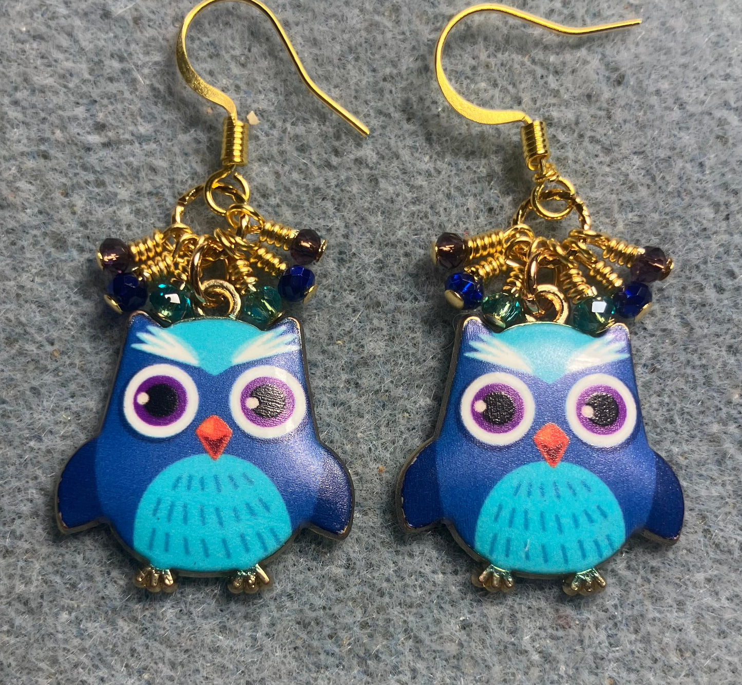 Dark blue, turquoise, and purple enamel owl charm earrings adorned with tiny dangling dark blue, turquoise, and purple Chinese crystal beads.