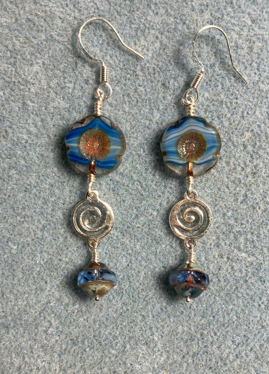 Blue striped Czech glass pansy bead earrings adorned with silver swirly connectors and blue Czech glass Saturn beads.