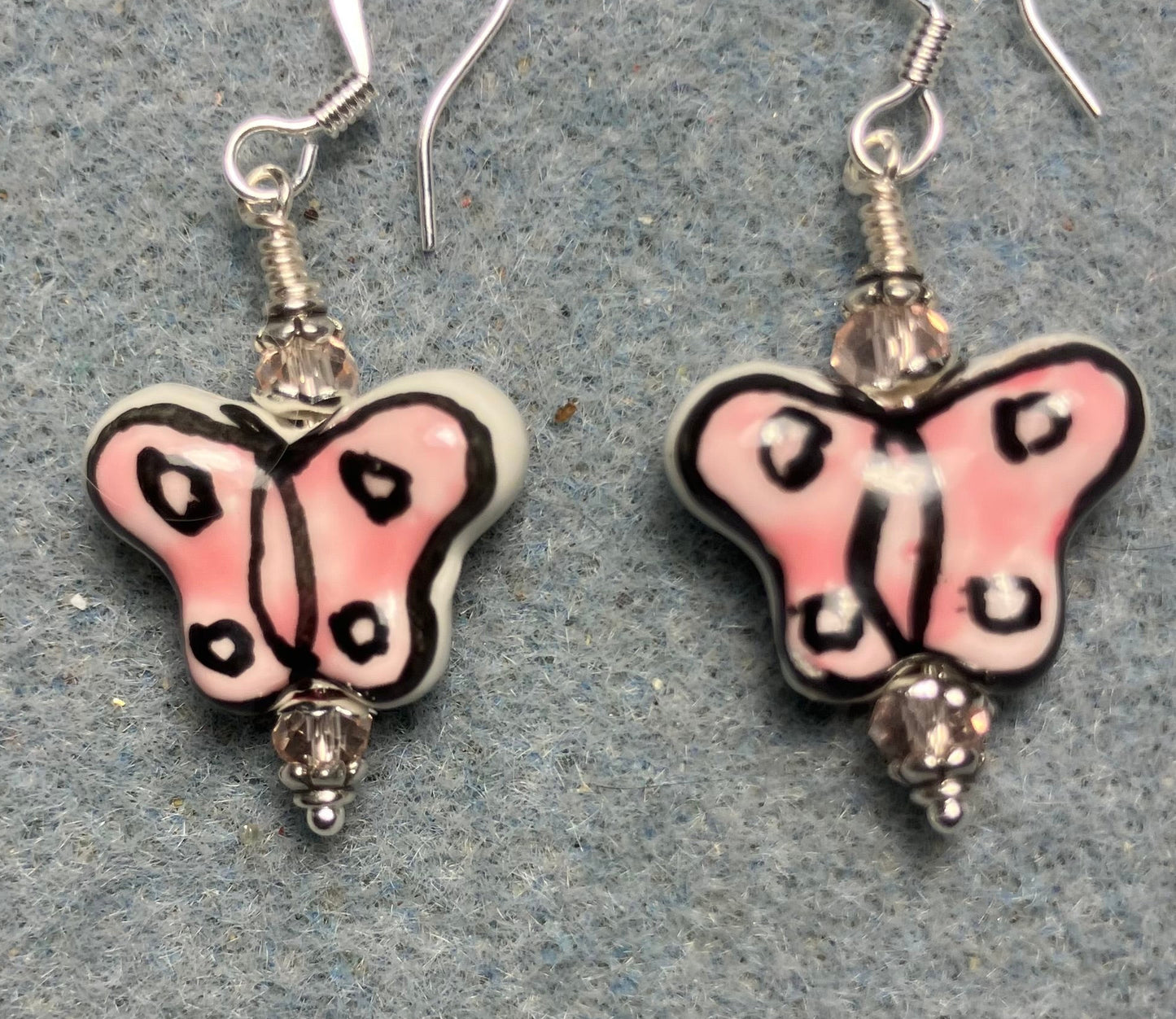 Pink and black ceramic butterfly bead earrings adorned with pink Chinese crystal beads.