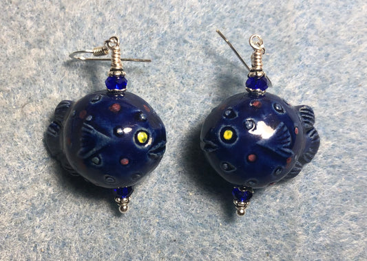 Dark blue ceramic blowfish bead earrings adorned with dark blue Chinese crystal beads.