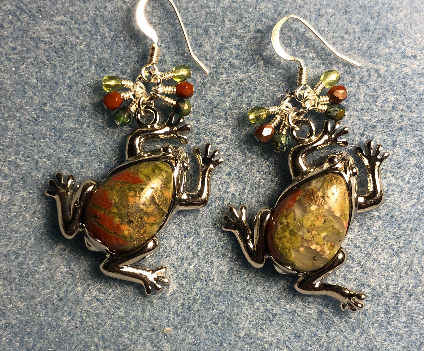 Large silver and green orange unakite goldstone gemstone frog charm earrings adorned with small dangling olive green and orange Czech glass beads.