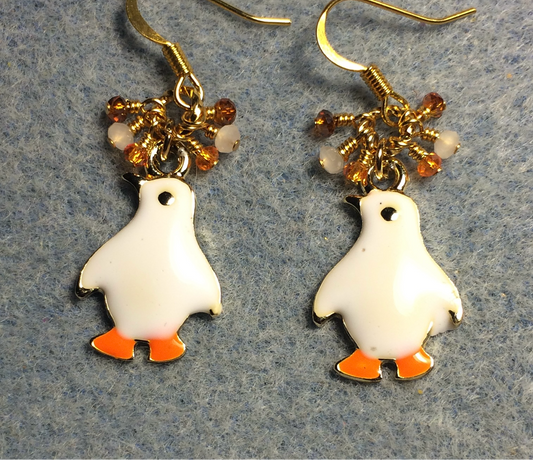 White and orange enamel penguin charm earrings adorned with tiny dangling white and orange Chinese crystal beads.