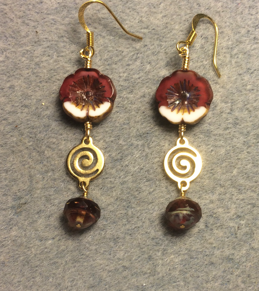 Cranberry red and white Czech glass pansy bead earrings adorned with gold swirly connectors and cranberry red Czech glass Saturn beads.