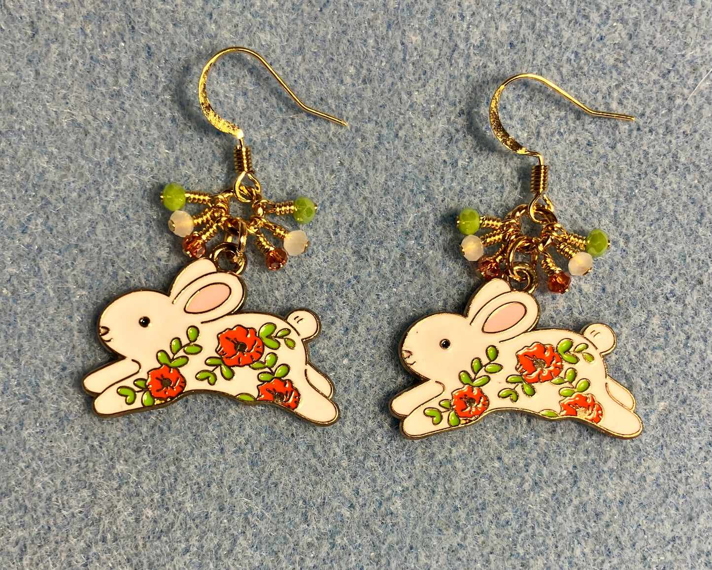 White, orange, and olive green enamel rabbit charm earrings adorned with white, orange, and olive green Chinese crystal beads.