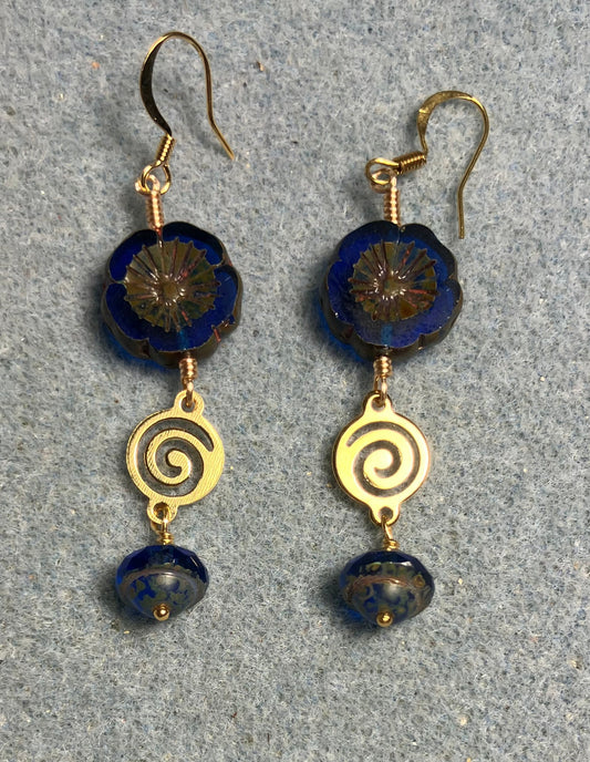 Cobalt blue Czech glass pansy bead earrings adorned with gold swirly connectors and cobalt blue Czech glass Saturn beads.