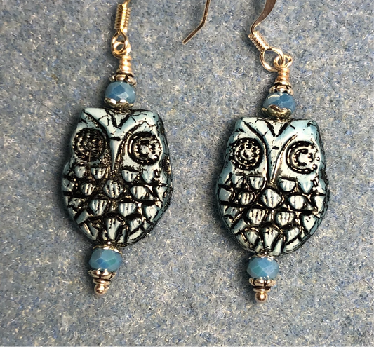 Light blue (with black wash) Czech glass owl bead earrings adorned with light blue Chinese crystal beads.