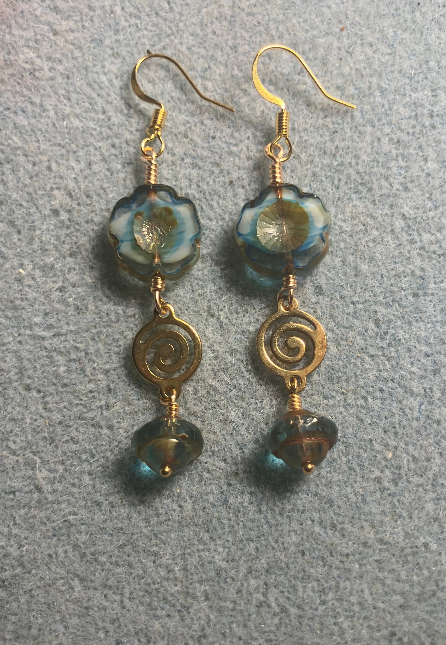 Turquoise and brown Czech glass pansy bead earrings adorned with gold swirly connectors and turquoise and gold Czech glass Saturn beads.
