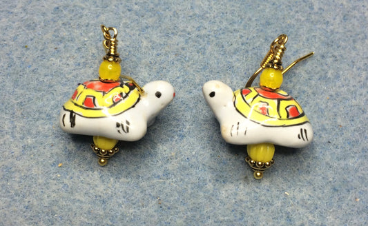 Yellow, orange, and white ceramic turtle bead earrings adorned with yellow Czech glass beads.