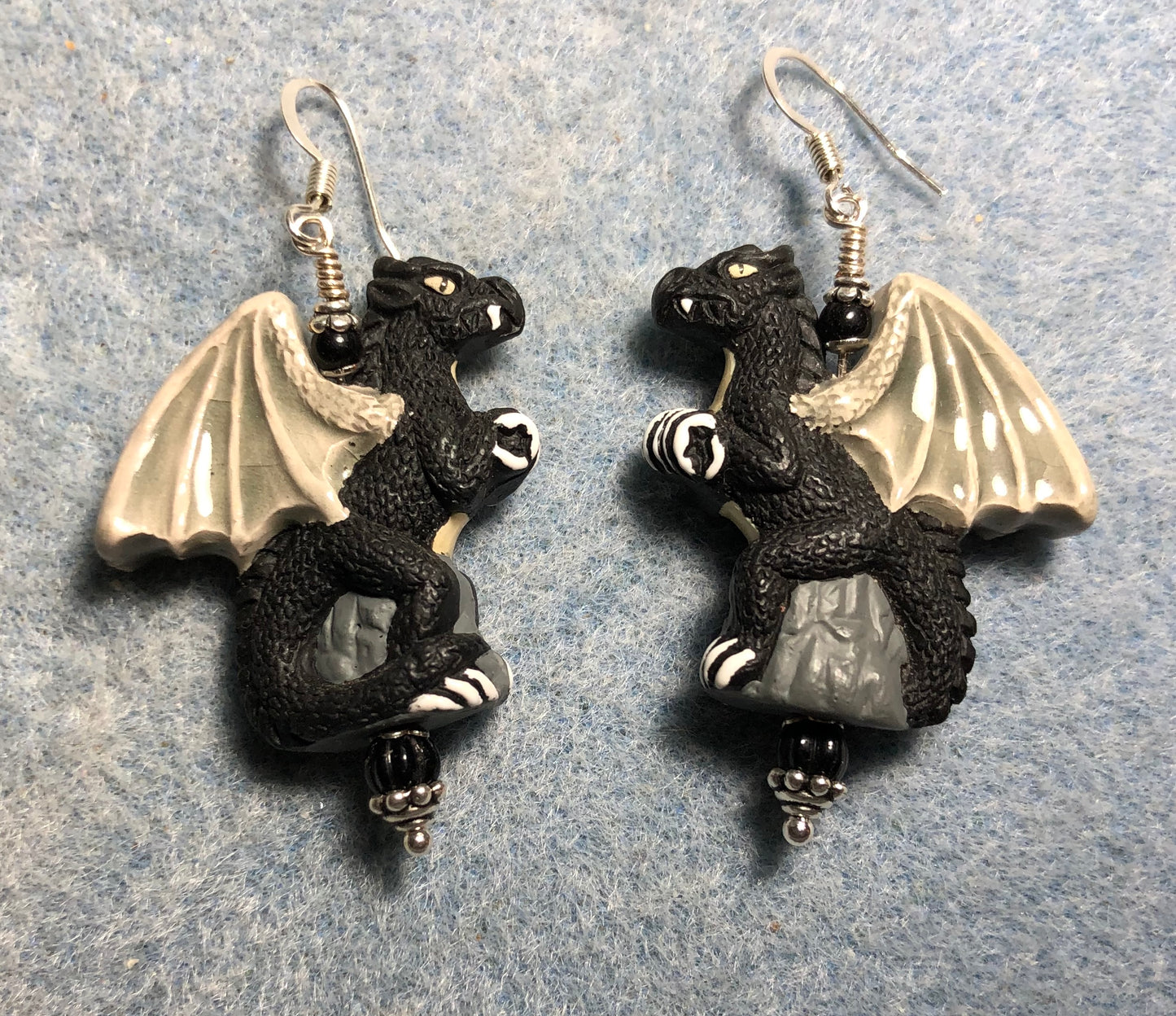 Large black dragon bead earrings adorned with black Czech glass beads.