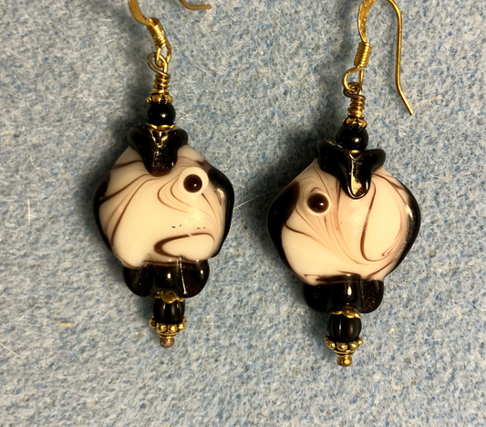 Large black and white lamp work fish bead earrings adorned with black Czech glass beads.