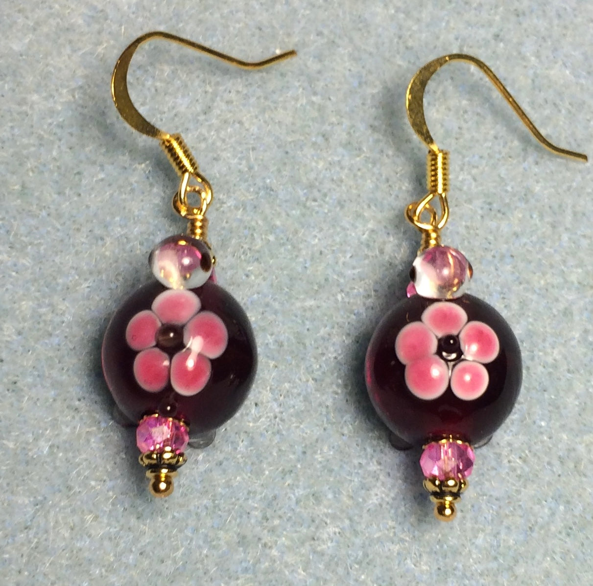 Dark red and pink lamp work turtle bead earrings adorned with hot pink Chinese crystal beads.