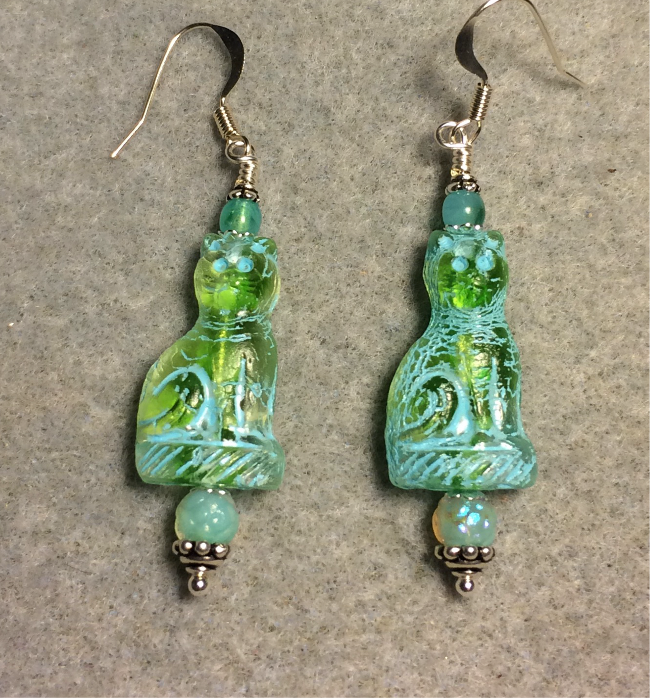 Translucent light green (with turquoise inlay) fancy Czech glass fancy cat bead earrings adorned with aqua green Czech glass beads.
