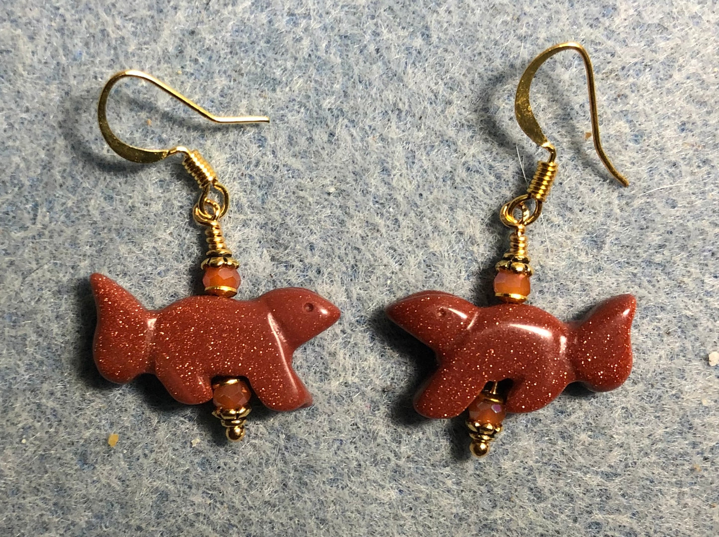 Orange goldstone gemstone squirrel bead earrings adorned with orange Chinese crystal beads.