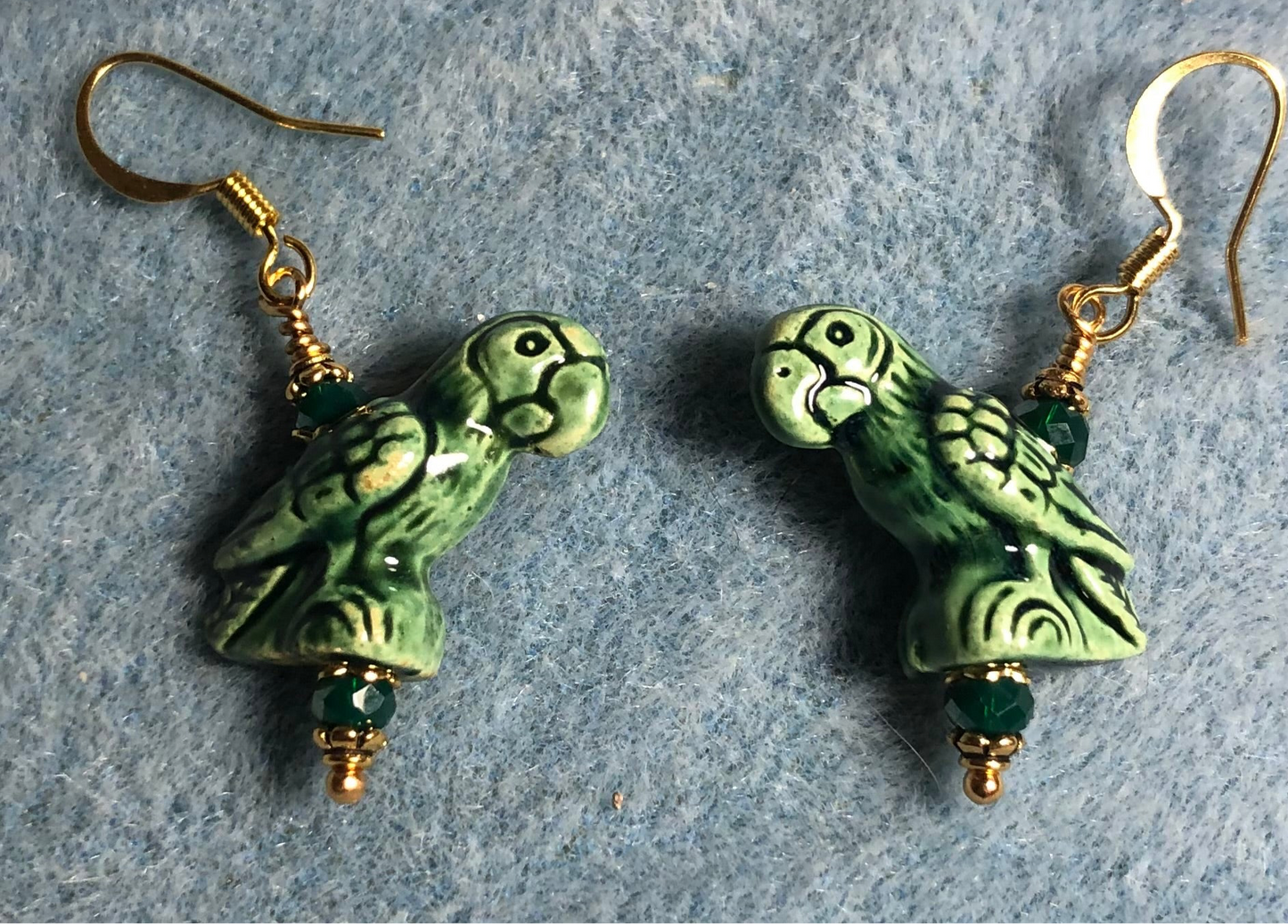 Dark green ceramic parrot bead earrings adorned with dark green Chinese crystal beads.