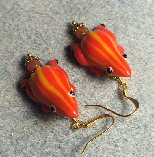 Orange with yellow stripes lamp work frog bead earrings adorned with orange Czech glass beads.