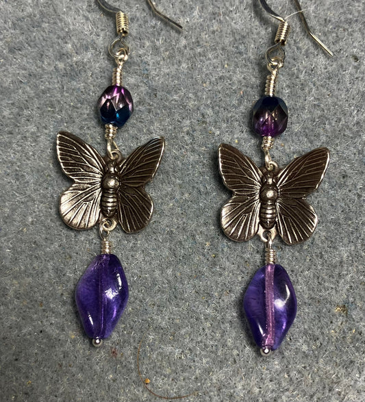 Silver butterfly charm connector earrings adorned with purple Czech glass twist beads and purple Czech glass beads.