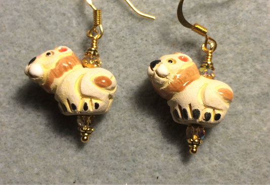 Small tan and orange ceramic lion bead earrings adorned with amber Chinese crystal beads.