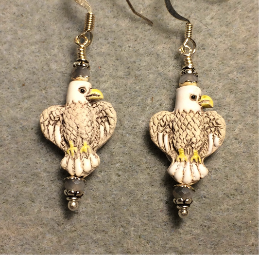 Small gray, white, and yellow ceramic flying eagle bead earrings adorned with gray white Chinese crystal beads.