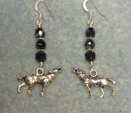 Silver howling wolf charm earrings adorned with black Czech glass beads.