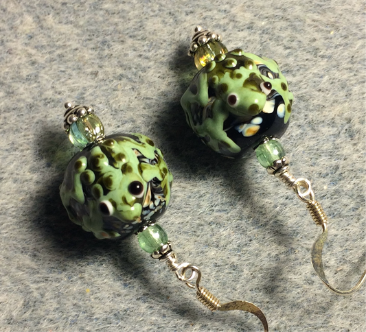 Black and light green lamp work frog bead earrings adorned with light green Czech glass beads.