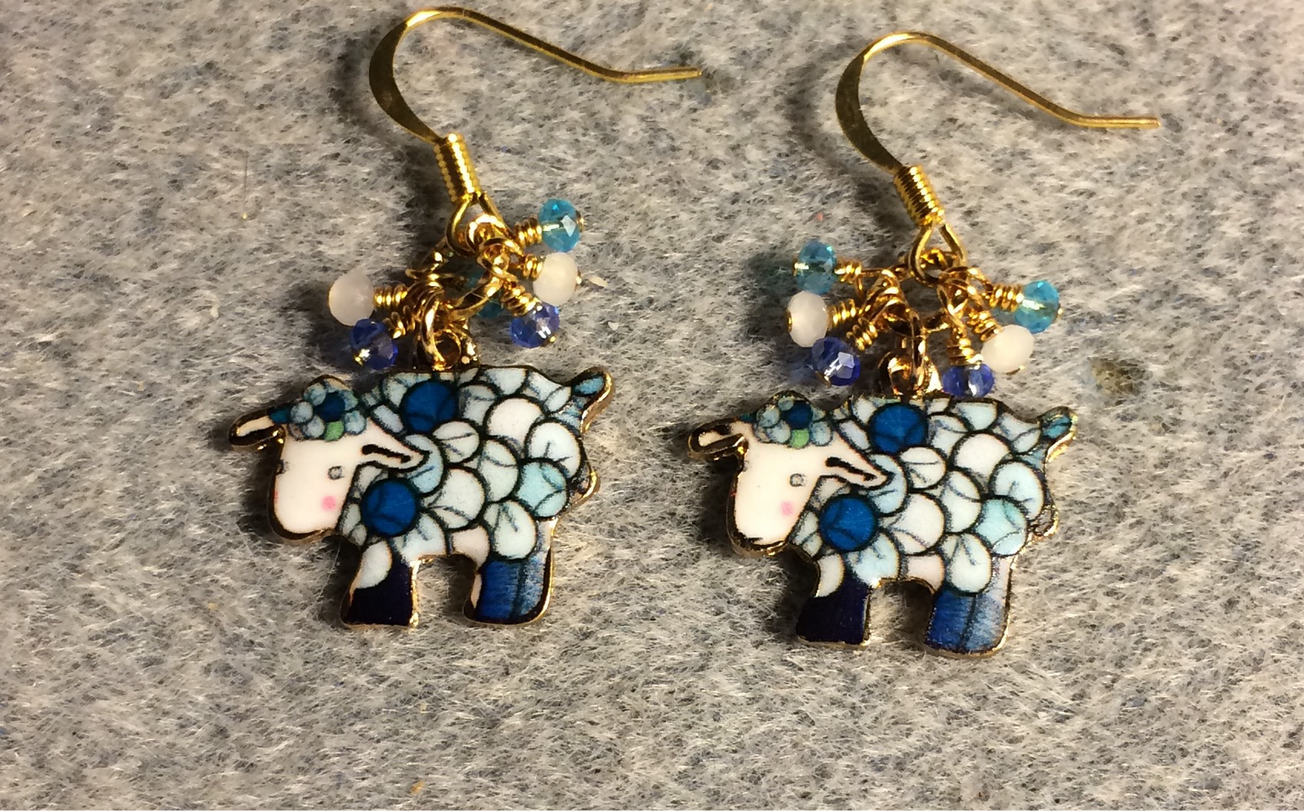 Dark blue, white, and turquoise enamel sheep charm earrings adorned with dark blue, white, and turquoise Chinese crystal beads.