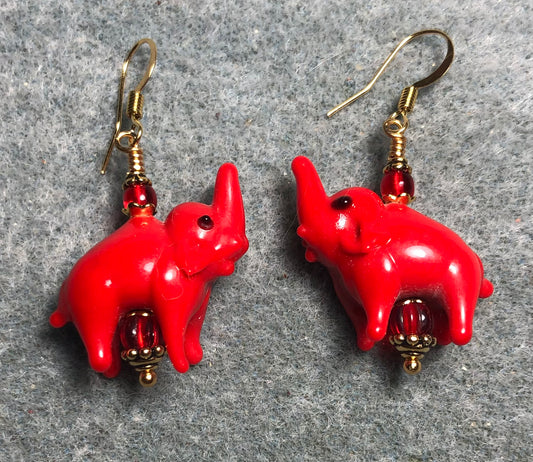 Opaque red lamp work elephant bead earrings adorned with red Czech glass beads.