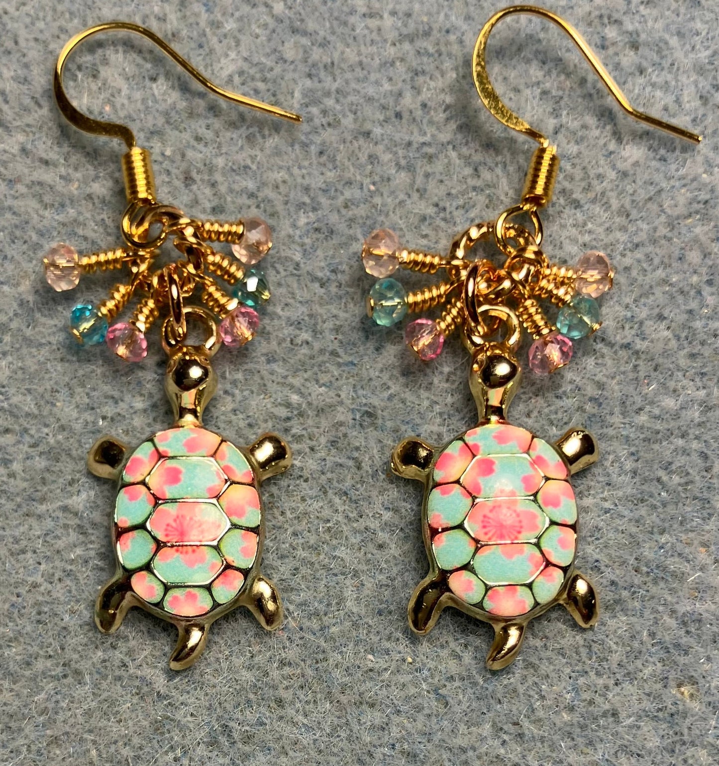 Pink and turquoise enamel turtle charm earrings adorned with tiny dangling pink and turquoise Chinese crystal beads.