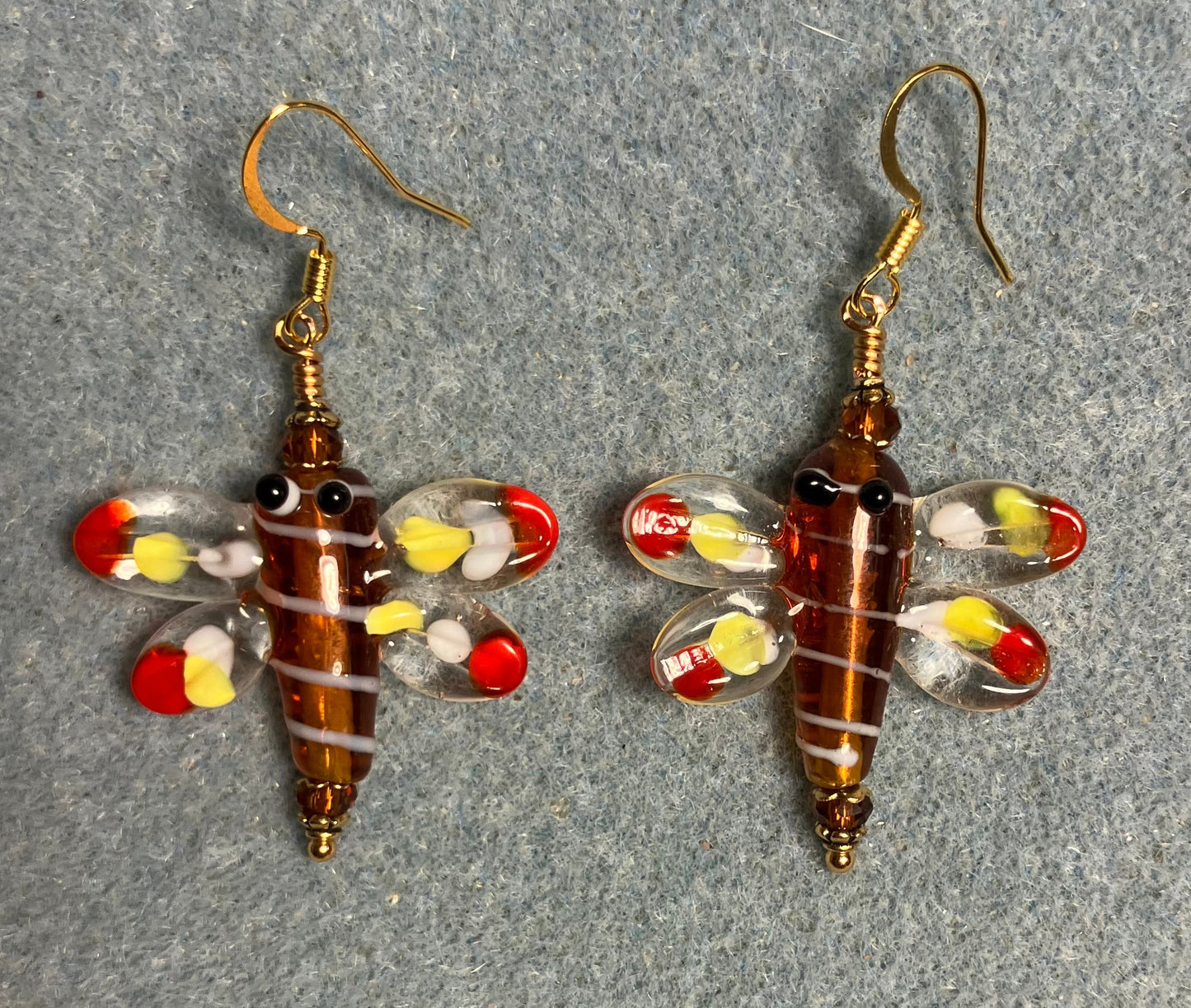 Brown, red, and yellow lamp work dragonfly bead earrings adorned with brown Chinese crystal beads.