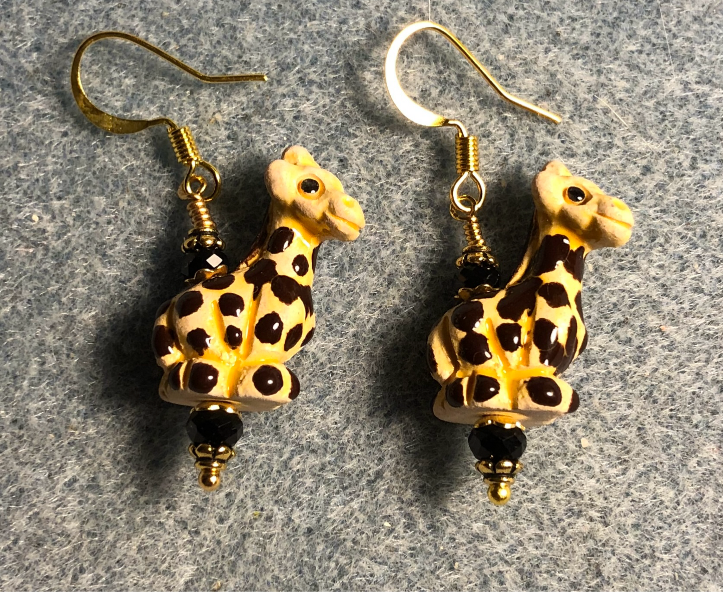 Small yellow and black ceramic spotted giraffe bead earrings adorned with black Chinese crystal beads.