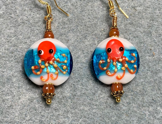 Turquoise, white, and orange lamp work octopus bead earrings adorned with orange Czech glass beads.