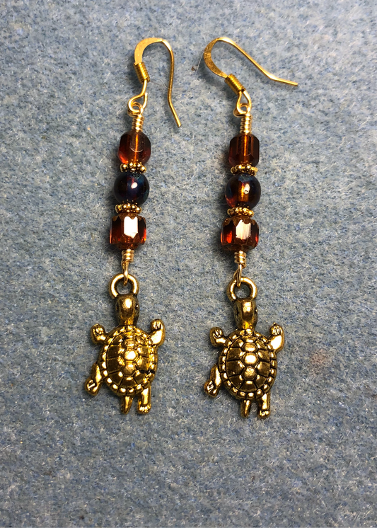 Gold tortoise charm earrings adorned with brown Czech glass beads