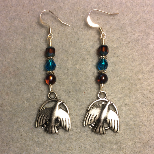 Silver hawk charm earrings adorned with brown and turquoise Czech glass beads