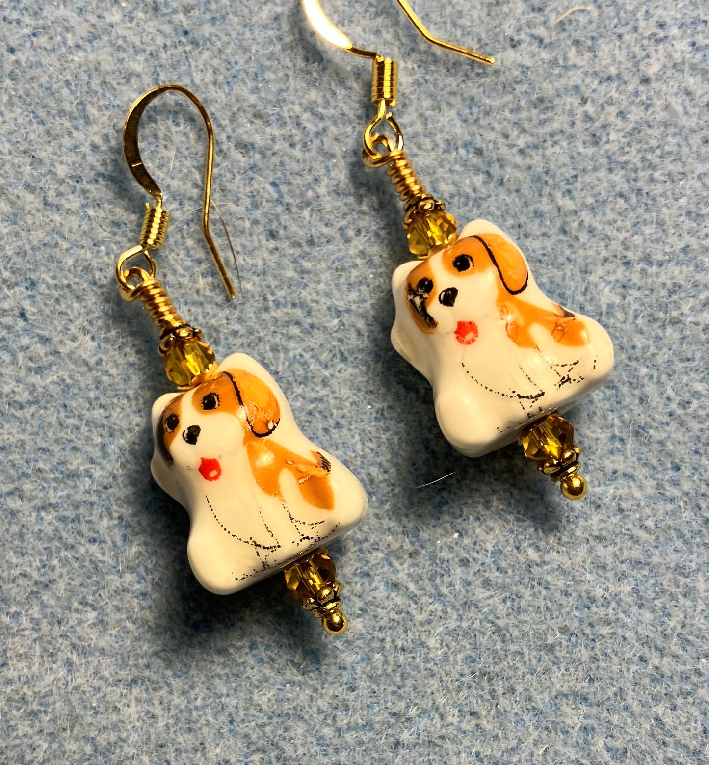 Amber and white ceramic puppy dog bead earrings adorned with amber Chinese crystal beads.