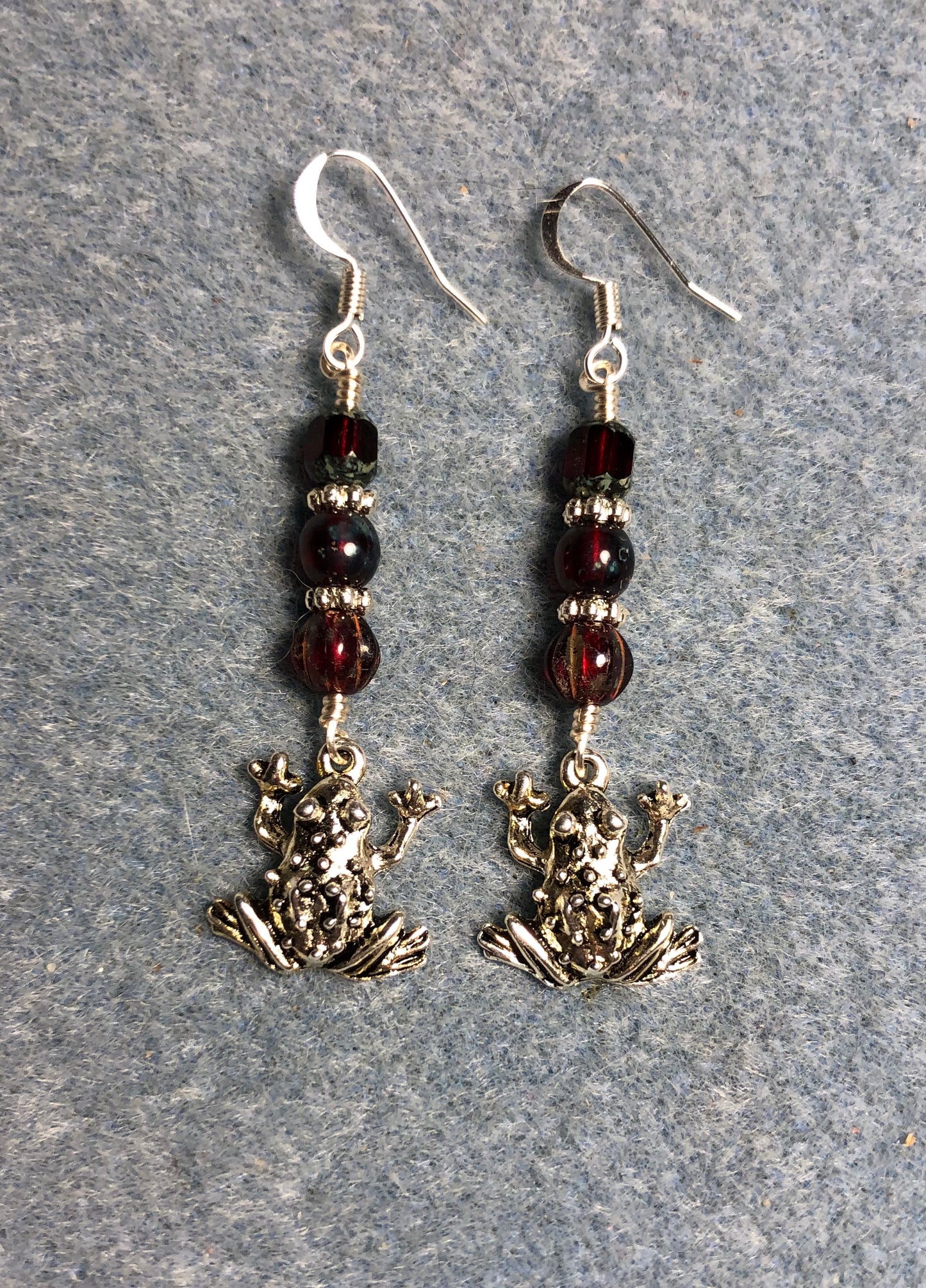 Silver frog charm earrings adorned with dark red Czech glass beads