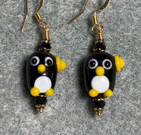 Black, white, and yellow lamp work owl bead earrings adorned with black Chinese crystal beads.