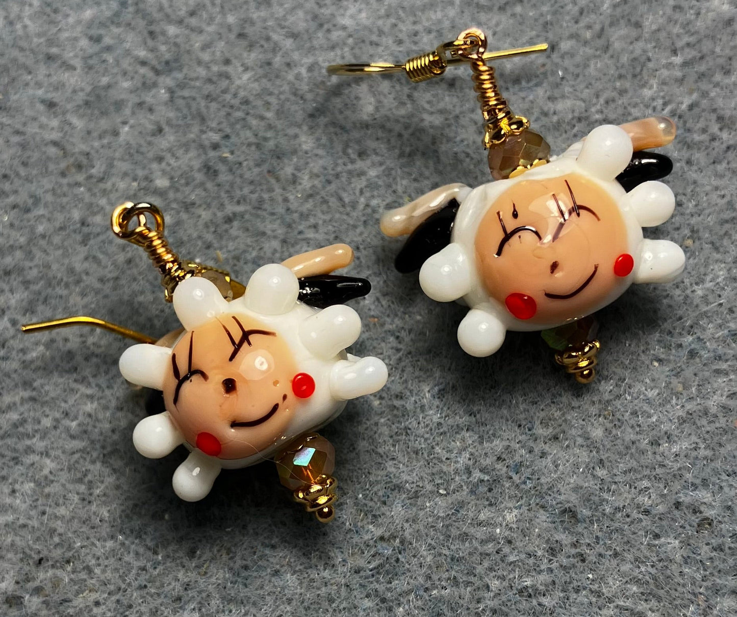 White, beige, and red lamp work sheep bead earrings adorned with beige Chinese crystal beads.