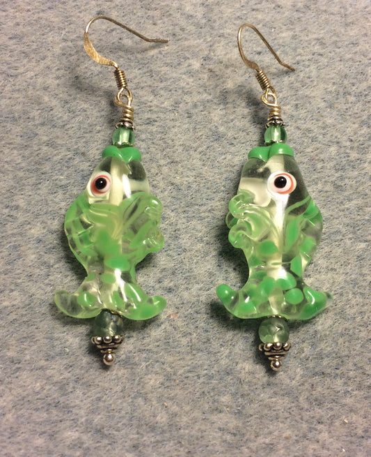 Light green and clear lamp work fish bead earrings adorned with light green Czech glass beads.