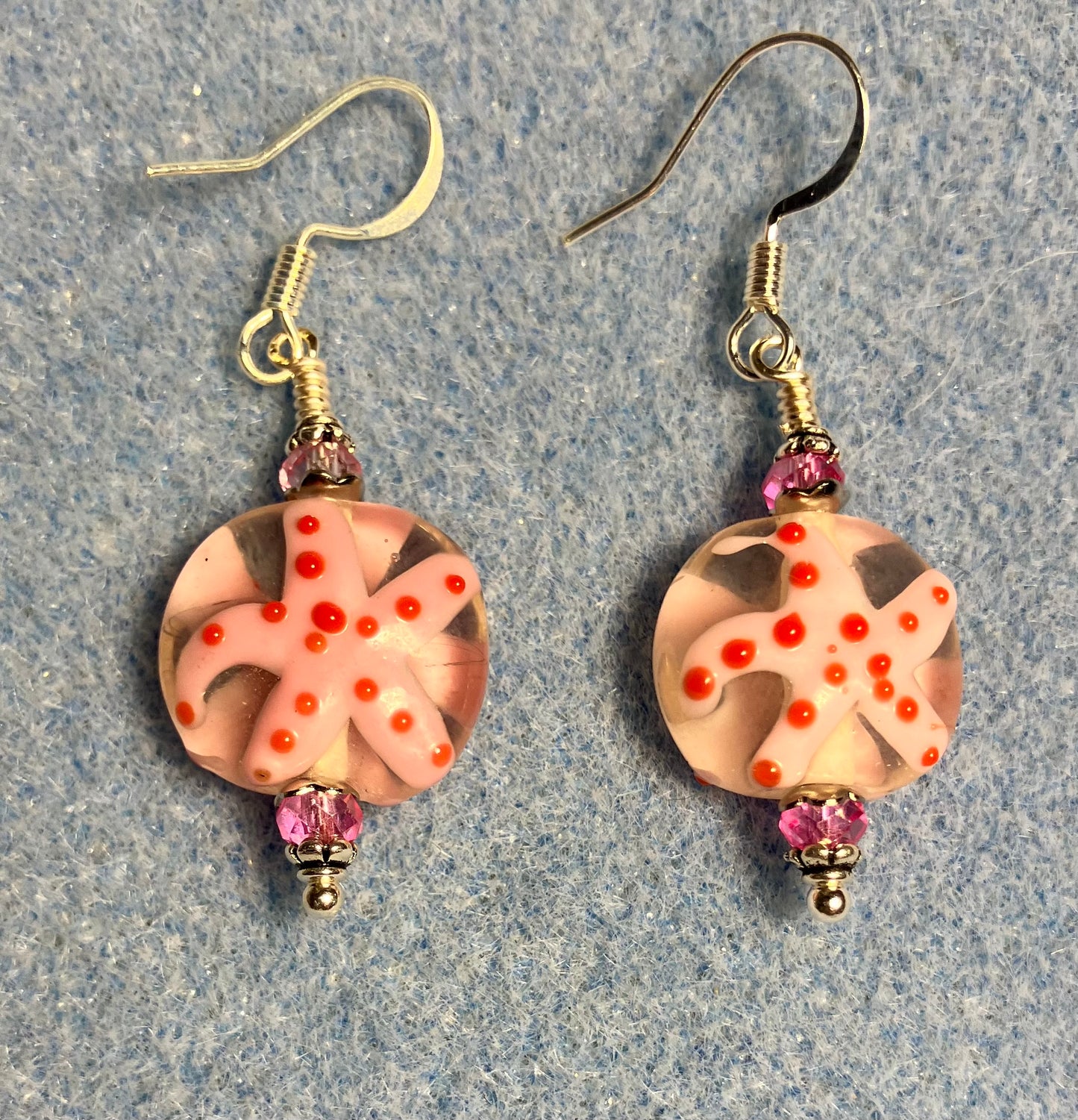 Light pink and hot pink lamp work starfish bead earrings adorned with hot pink Chinese crystal beads.