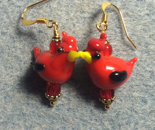Red and black lamp work songbird bead earrings adorned with red Czech glass beads.