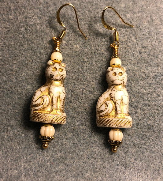 White (with gold inlay) fancy Czech glass cat bead earrings adorned with white Czech glass beads.