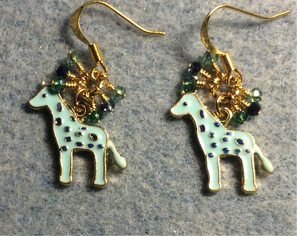 Light aqua enamel spotted giraffe charm earrings adorned with tiny dangling aqua, black, and teal Chinese crystal beads.